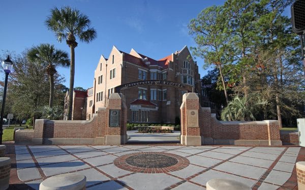 Heavener Hall in the background with the UF Archway and seal in the foreground.