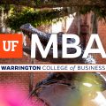 Bronze statue of an alligator on top of a globe with trees in the background and the UF MBA logo on top.