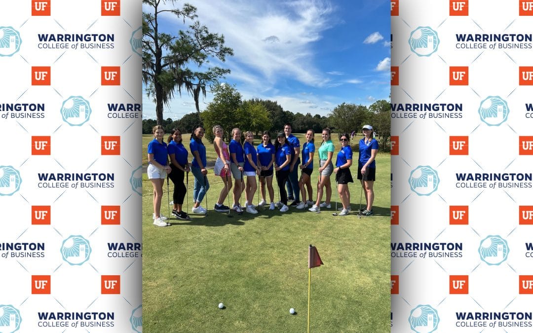 Group of young women posing for a photo on a golf course on a sunny day