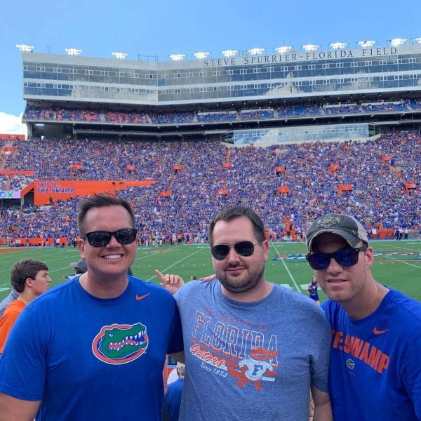 Monte Gehrtz with two friends at Ben Hill Griffen Stadium during a Florida football game.