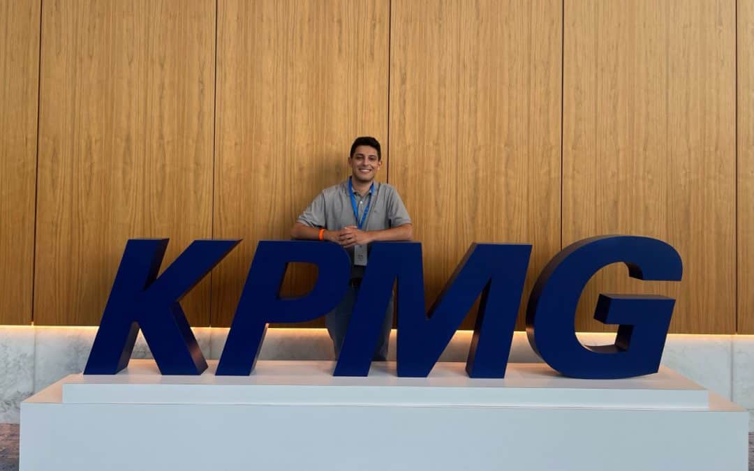 Homar Ali with a large KPMG sign