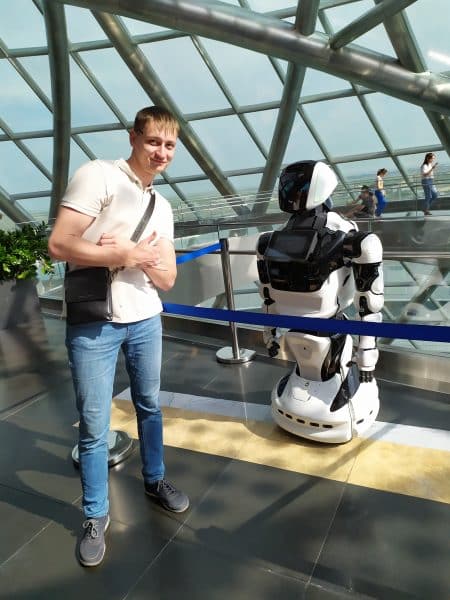 Igor Savin poses with a robot.