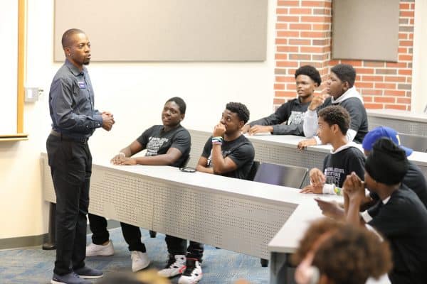 Jeff Danso speaks in a classroom with a group of students in the Made for More program.