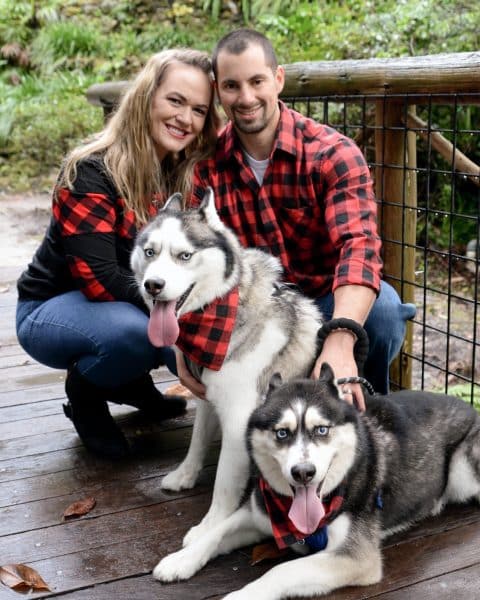 Schweitzer poses with her partner and two dogs.
