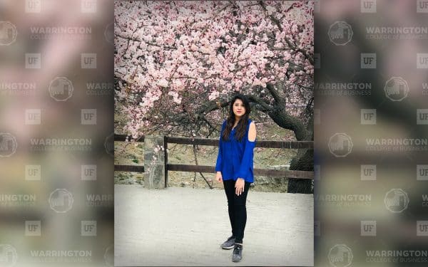 Priyanka Pahuja in front of a cherry blossom tree in bloom