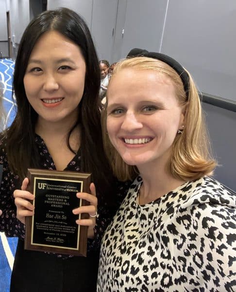 Hae Jin So holds her award from the UF International Center with Carly Escue.