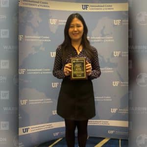 UF MBA and MS-ISOM student Hae Jin So holds her award from the UF International Center International Student Awards.