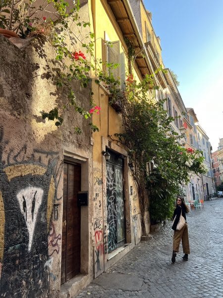 Jessica Lampner poses next to colorful houses in Rome.