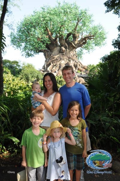 John Banko poses with his family under a tree.