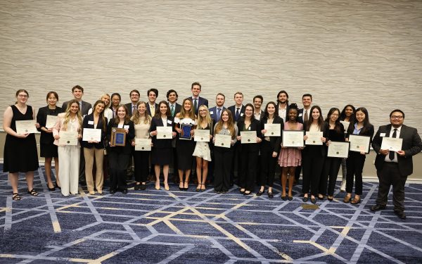 Fisher School of Accounting students holding awards.