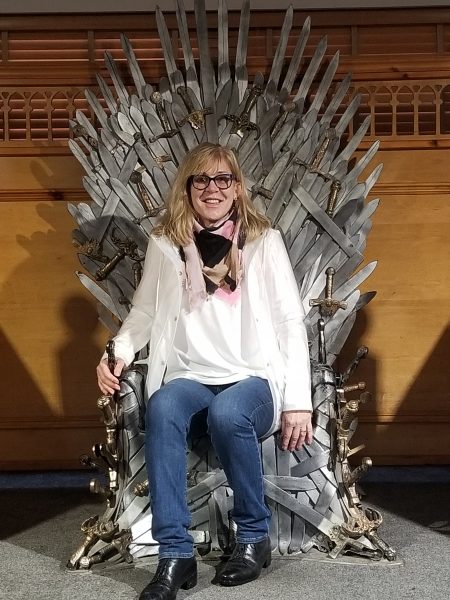 Judy Callahan sits on a throne made of swords.