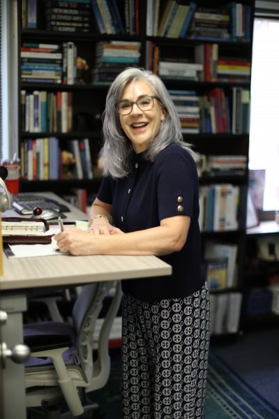 Judy Callahan stands at her desk.