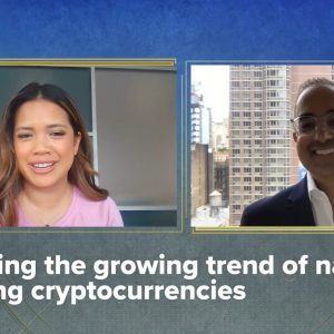 Two people talking via Zoom with text below their video screens that reads, Tracking the growing trend of nations holding cryptocurrencies.