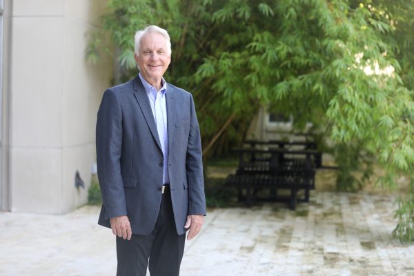 David Ling stands in front of bamboo plants.