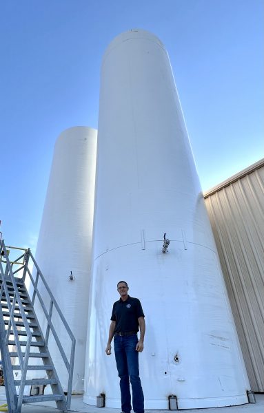 Matt McLean stands in front of some of Uncle Matt's Organic operational equipment