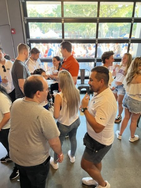 UF MBA students networking at an event.