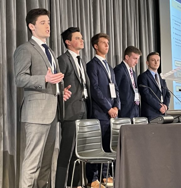 Five students present at a case competition.