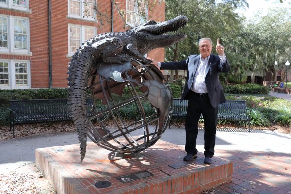 Richard Lutz poses with GUS statue.