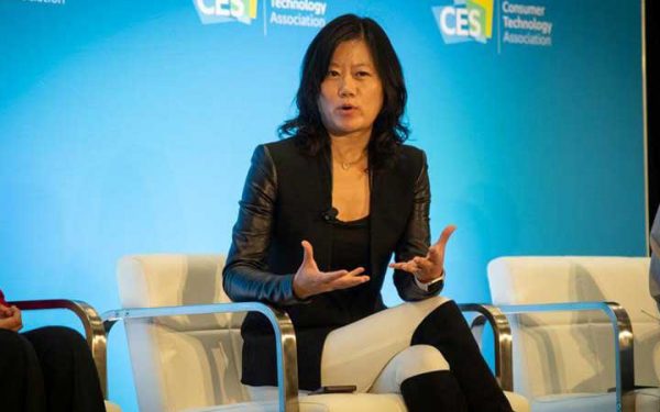 Heng Xu speaking on stage during a panel discussion.