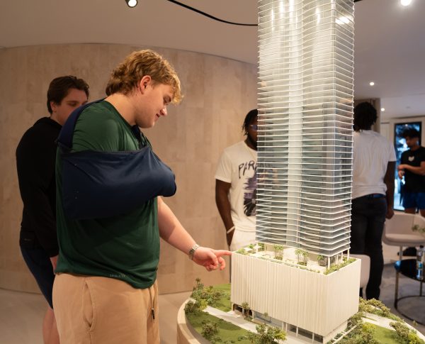A student examines a real estate model.