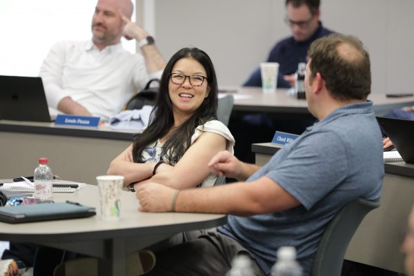 Students laughing in a conference room.