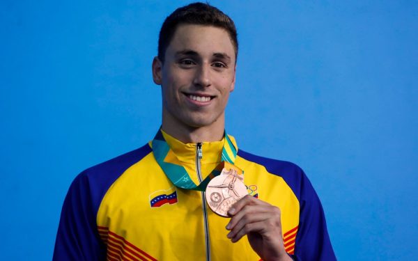 Alfonso Mestre holds a medal.