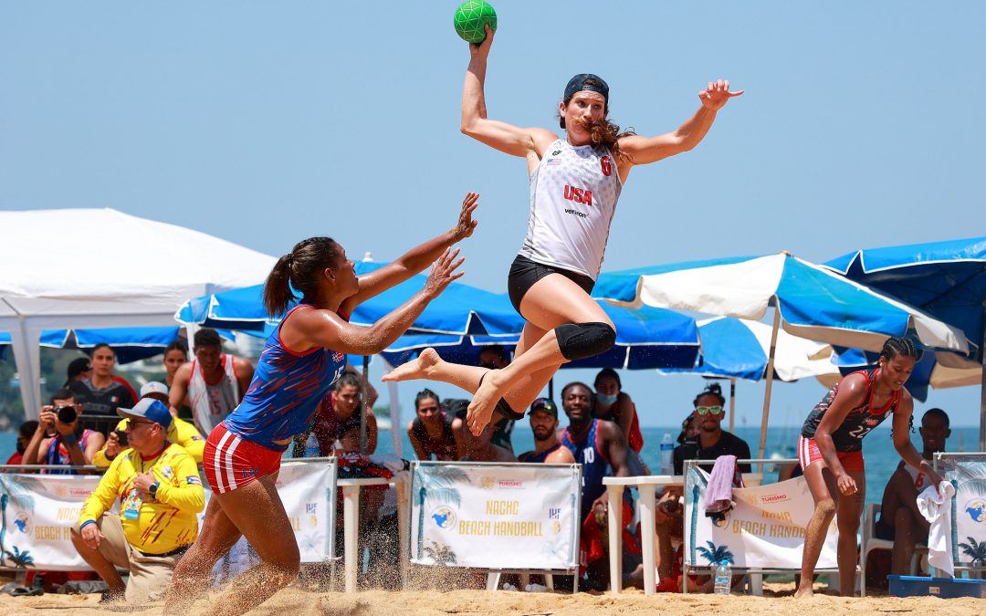Christine Mansour leaps with a green ball to avoid an opponent.