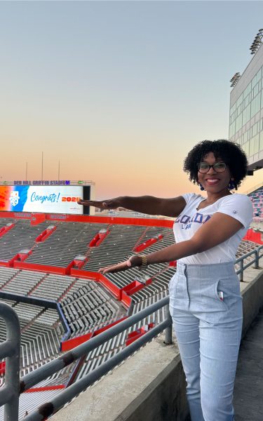 Lisa Thelwell does the Gator Chomp at Ben Hill Griffin Stadium during the 40 Gators Under 40 celebration.
