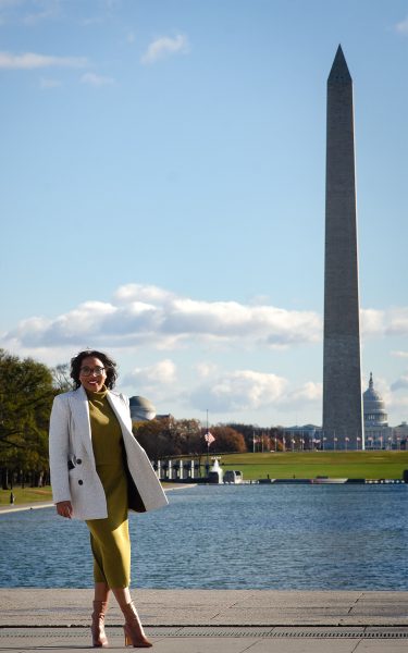 Lisa Thelwell poses for a photo in front of the Washington Monument in Washington, D.C.