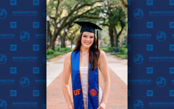 Chloe Grimme poses in graduate regalia.