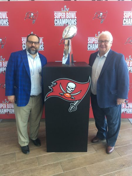 Andres and Luciano Prida, Jr. pose with the Super Bowl trophy.