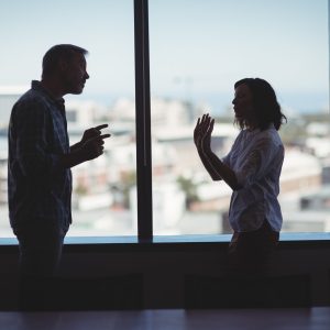 Business couple arguing near the window