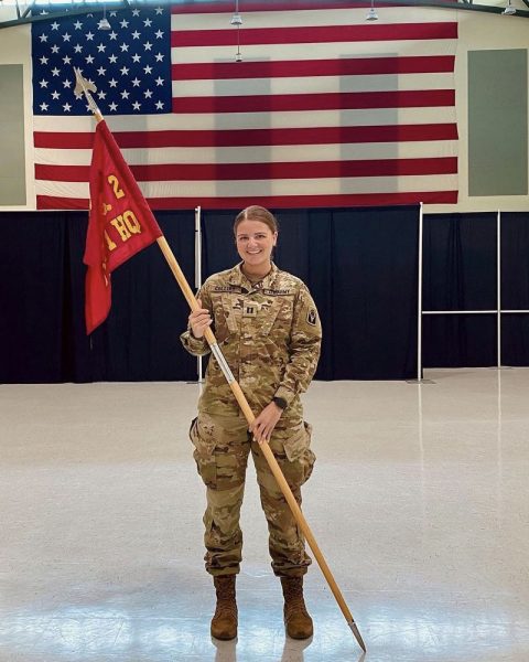 Lindsay Collins with United States military flags.