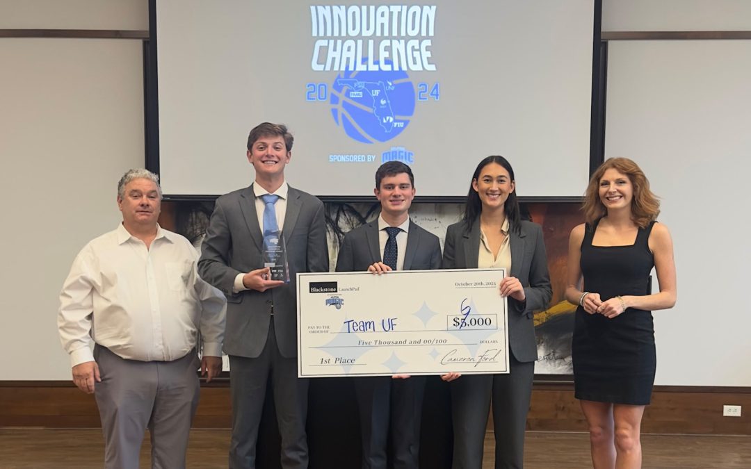 University of Florida students hold awarded first place $6,000 check under a projection reading Innovation Challenge.