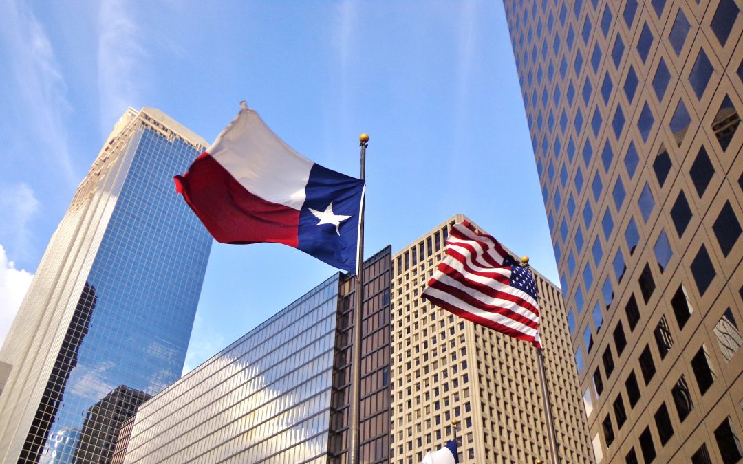 Low angle view of United States of America flag and Texas state