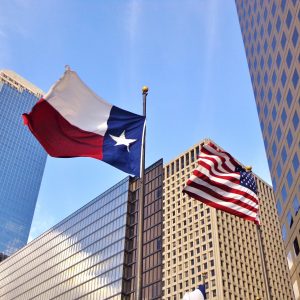 Low angle view of United States of America flag and Texas state