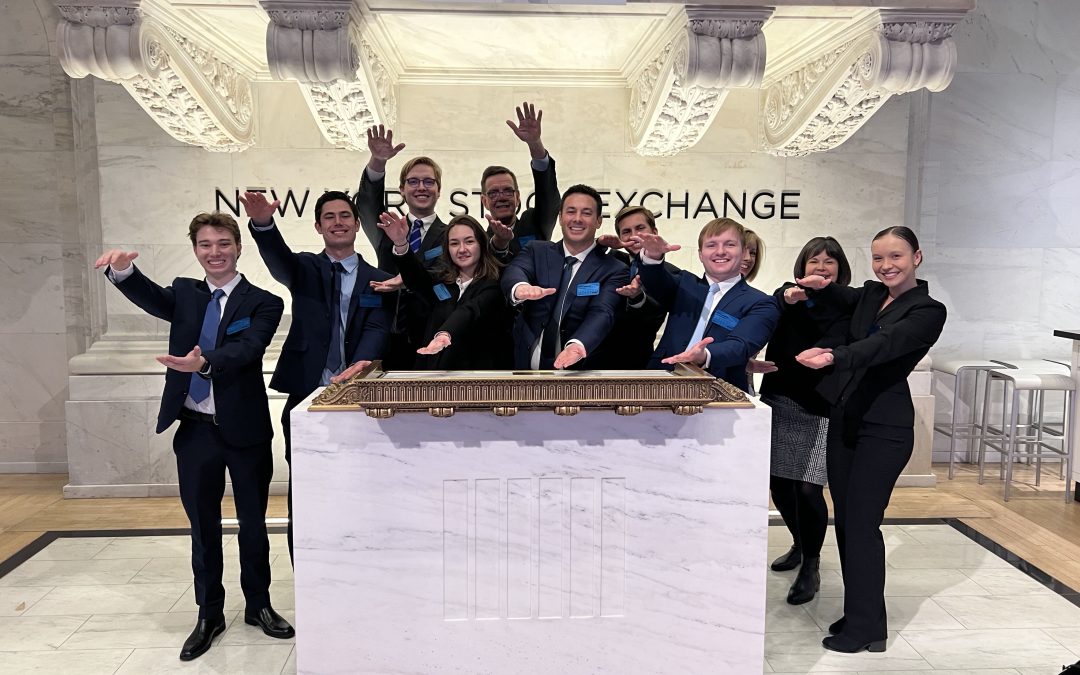 A group of students do the Gator Chomp at the New York Stock Exchange.