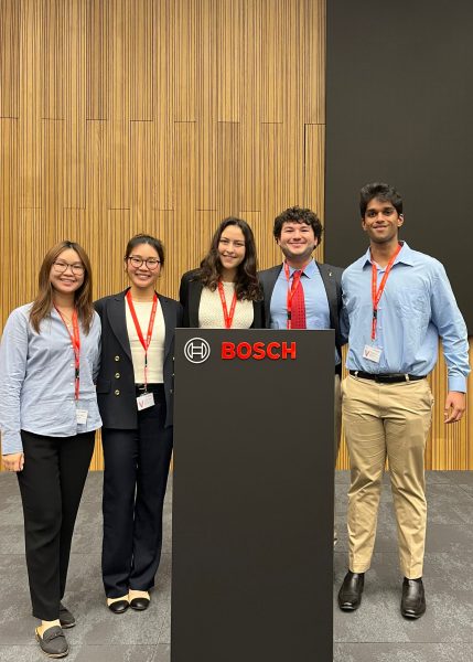 A group of students present at a Bosch podium.