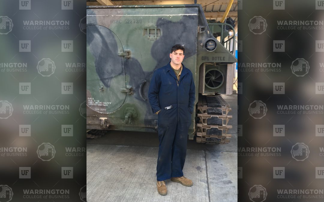 Bryan Doyle in front of a military vehicle.