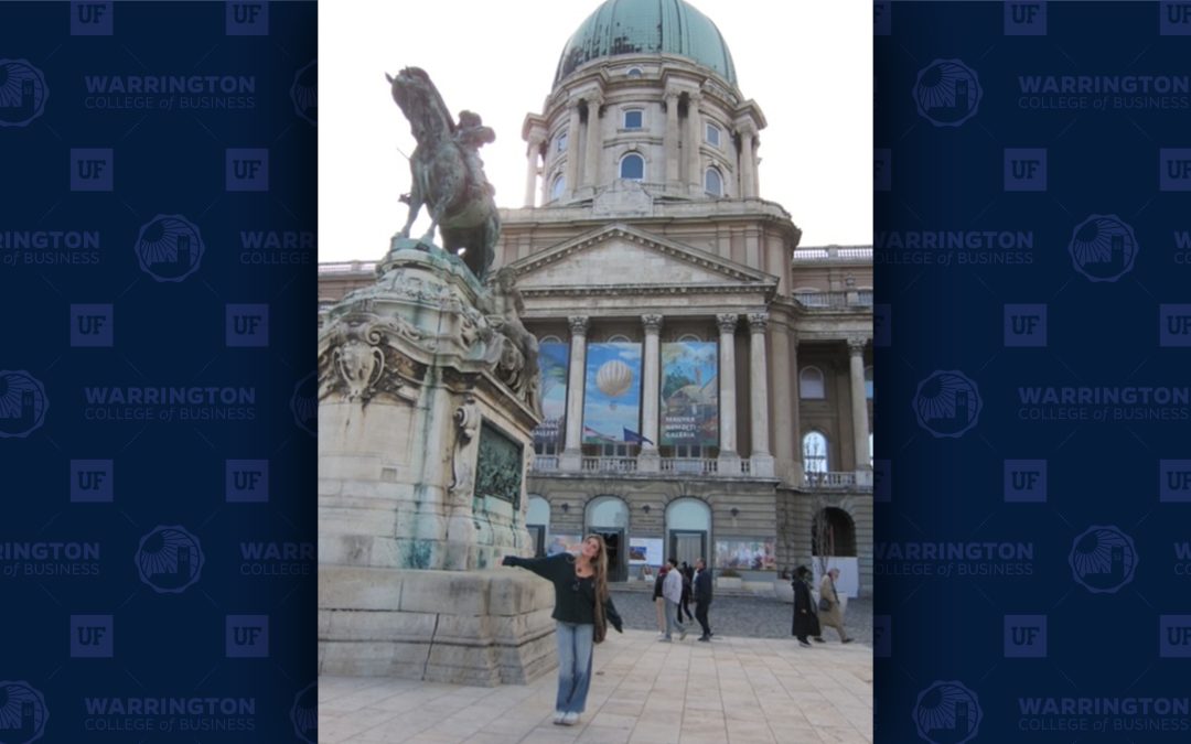 Mia Molinelli poses in front of a historic Hungarian building.