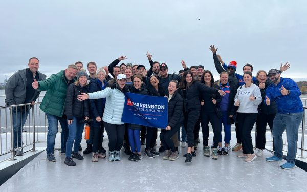 Warrington MBA students display a school banner in Oslo, Norway.