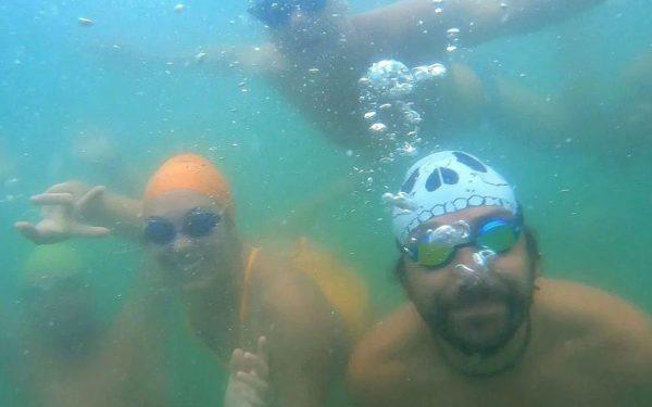 Divers pose underwater.