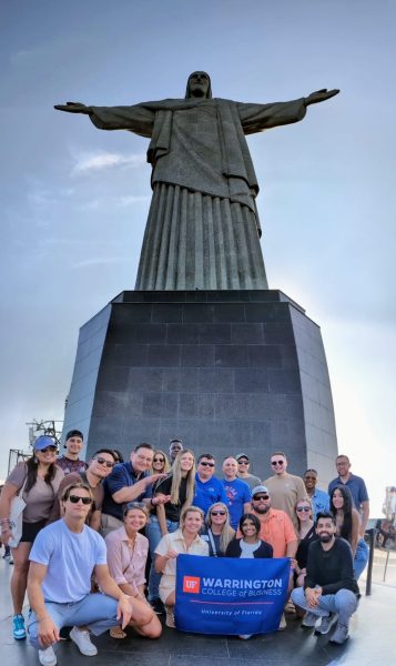 MBA students pose with Christ the Redeemer statue in Brazil.