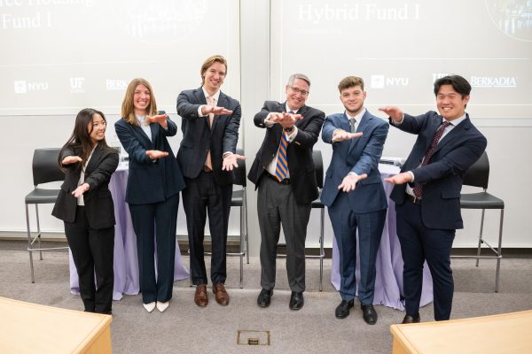 The winning team does the Gator chomp with their faculty advisor, Tim Becker.