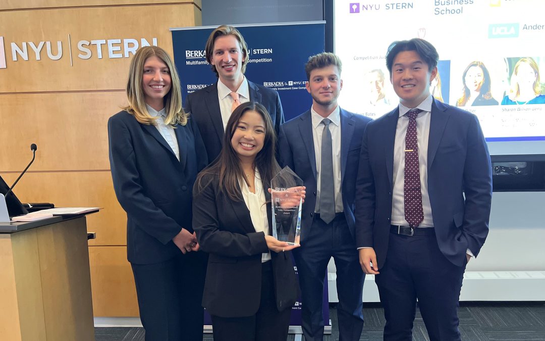 Five students display their first-place award at a case competition.