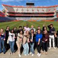 A group of about 20 students do the Gator chomp in Ben Hill Griffin Stadium.