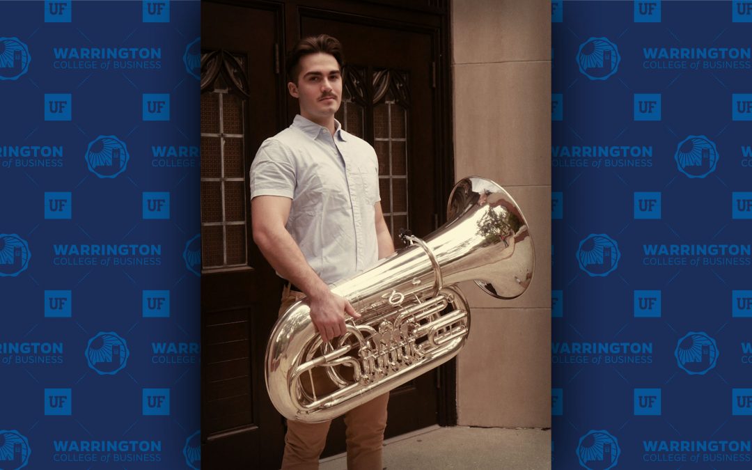 Luke Plugge holds a tuba
