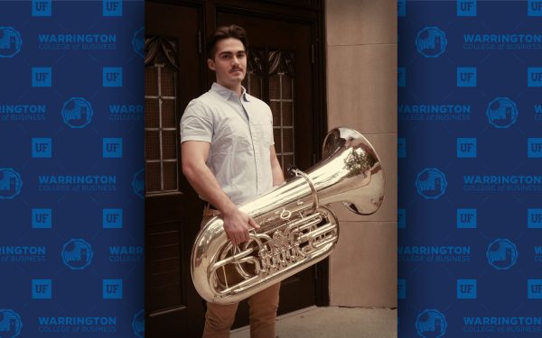 Luke Plugge holds a tuba