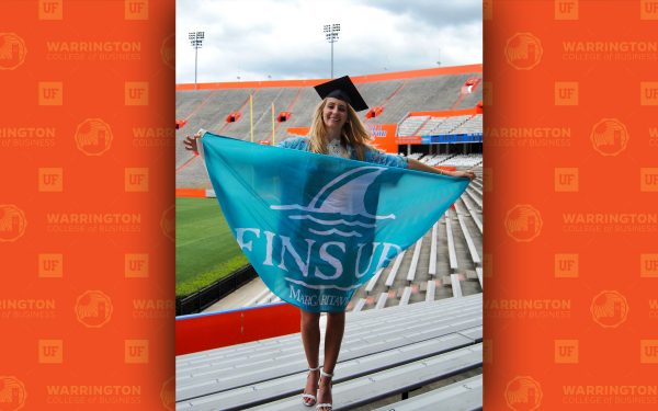 kristina genovese with fins up margaritaville flag in the UF football stadium