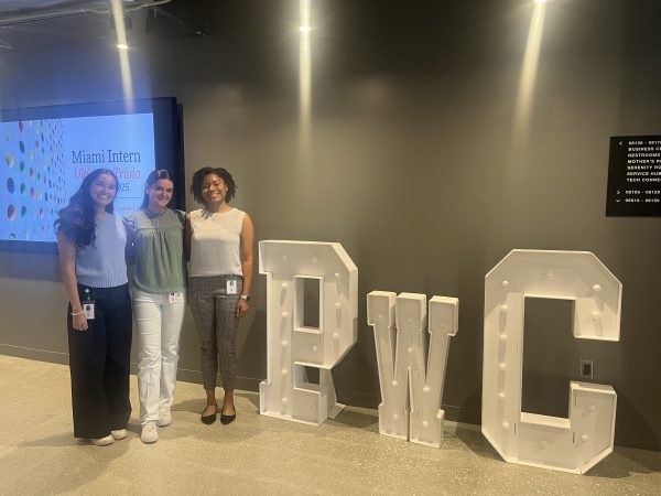 Toni-Anne (BSAc ’24, MAcc ’25) smiling with fellow interns near a PwC sign.